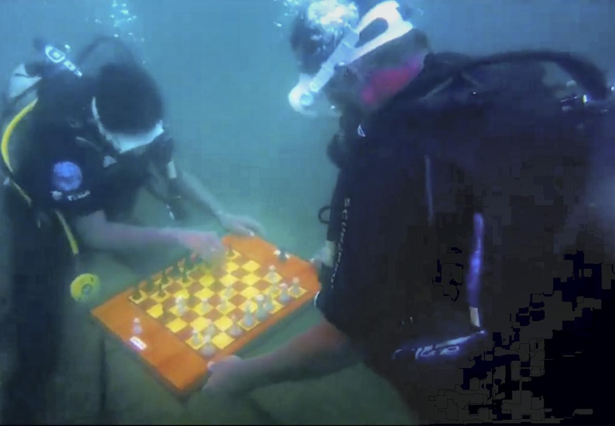 Scuba divers play a game of chess underwater near Neelankarai beach in 