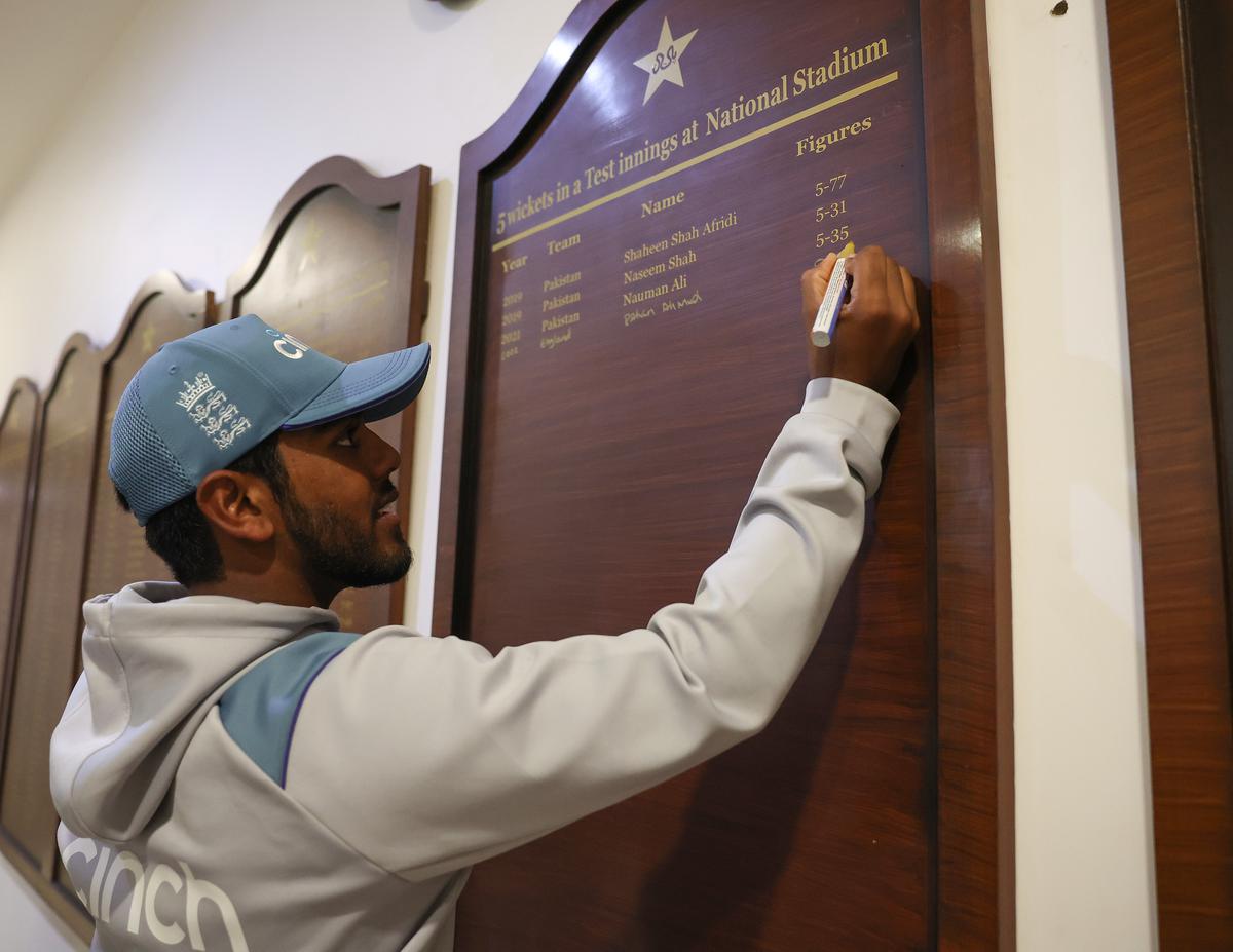 Rehan Ahmed of England signs a honours board to commemorate his 5 wickets, after becoming the youngest debutant in men’s Test history to take a five-for during Day 3 of the third Test between Pakistan and England at Karachi National Stadium on December 19, 2022 in Karachi, Pakistan.