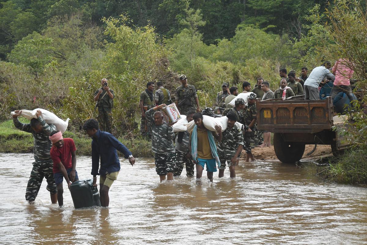 Security forces transporting goods across the Burha river.