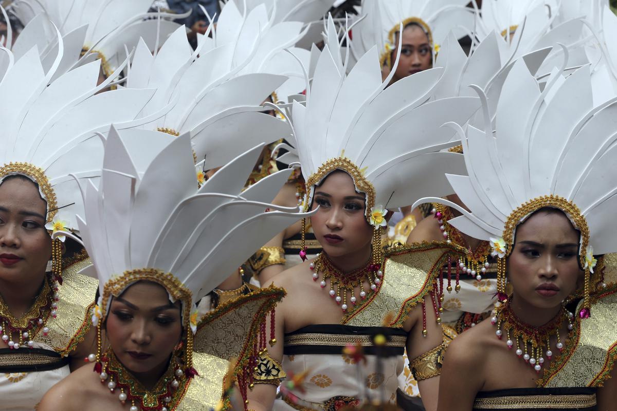 Women dancers prepare before their performance during the culture parade to bid farewell to 2022 and welcome 2023 in Bali, Indonesia on Saturday, Dec. 31, 2022.