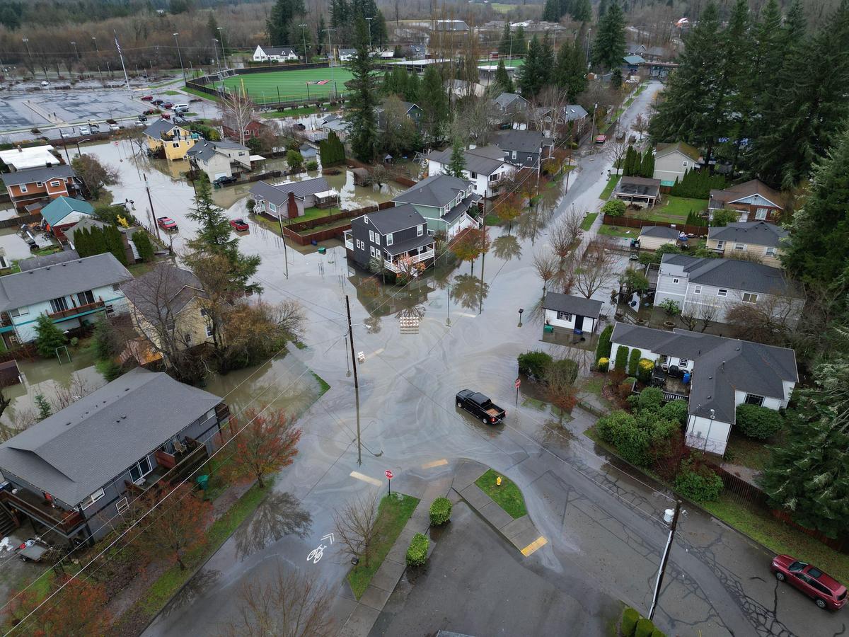 Some residential streets in downtown Snoqualmie, Washington, have standing water, Thursday morning, December 11, 2025, as the downtown braces for a third crest of the Snoqualmie River later. Photo credits: The Seattle Times via AP Some residential streets in downtown Snoqualmie, Washington, have standing water, Thursday morning, December 11, 2025, as the downtown braces for a third crest of the Snoqualmie River later. Photo credits: The Seattle Times via AP