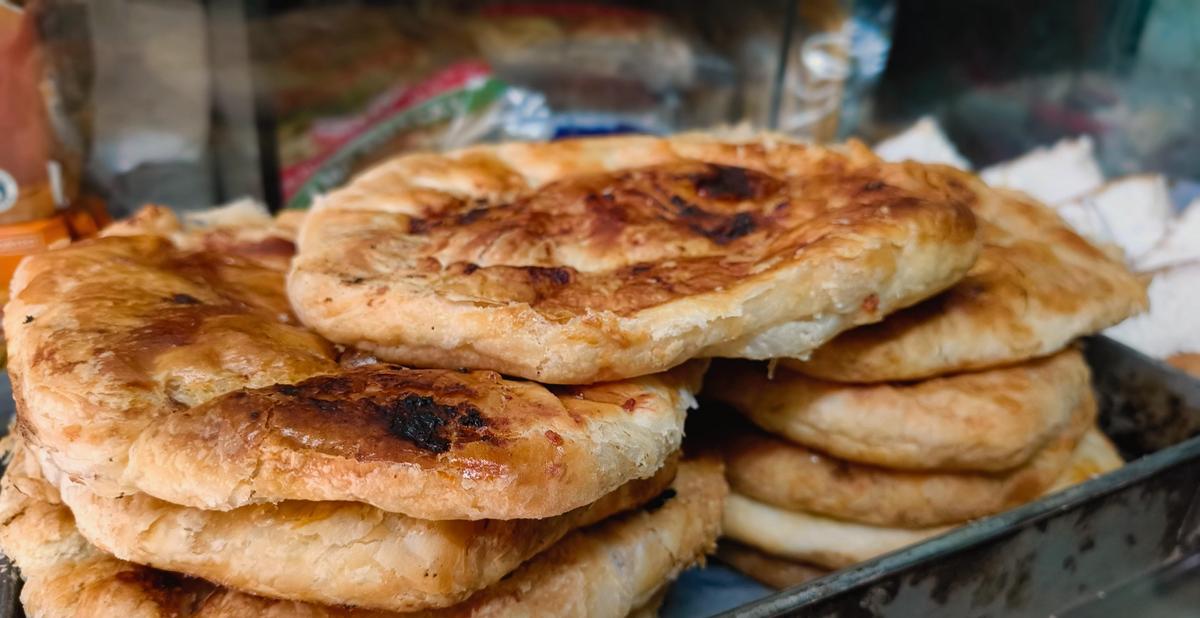 Stack of hot baked puffs at Sri Muthu Eshwaran Bakery and Sweets in Madurai. 