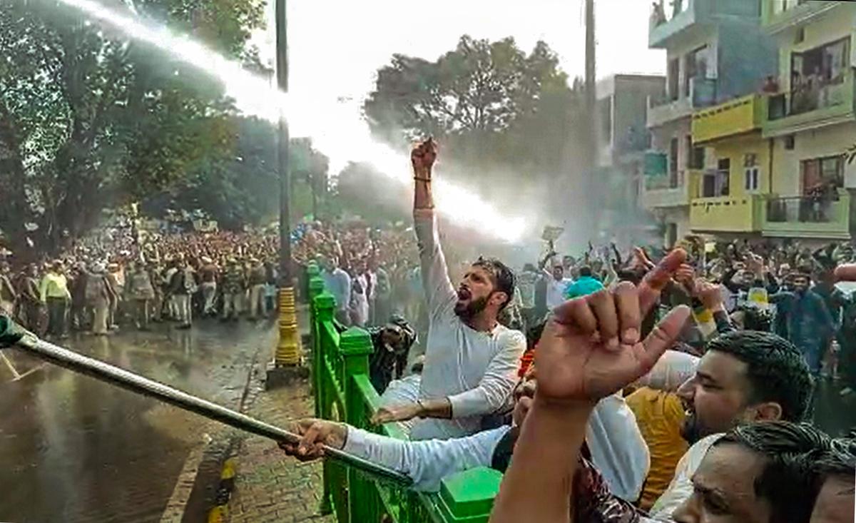 Water cannons being used as government employees of Haryana shout slogans during a protest demanding the restoration of the Old Pension Scheme, near Haryana Chief Minister Manohar Lal Khattar’s residence in Panchkula, Sunday, Feb. 19, 2023.