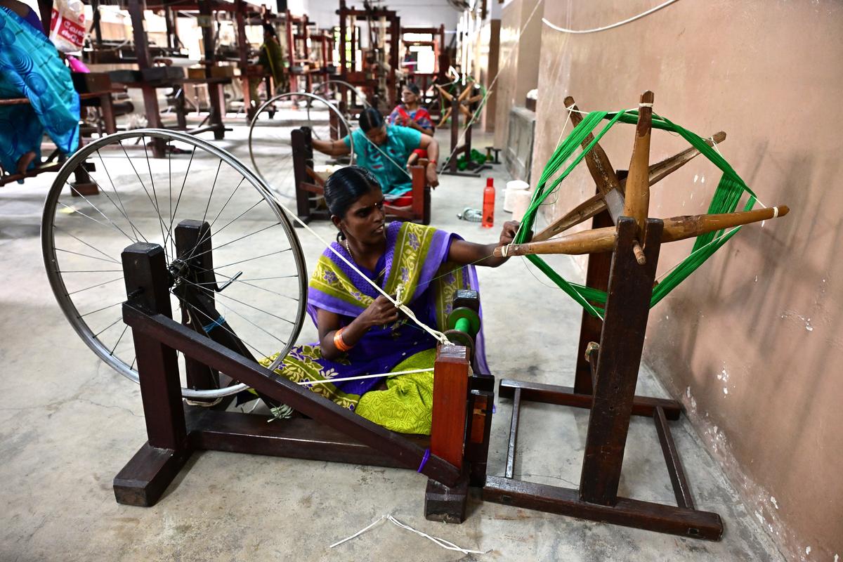 A visually-impaired artisan weaves cloth 