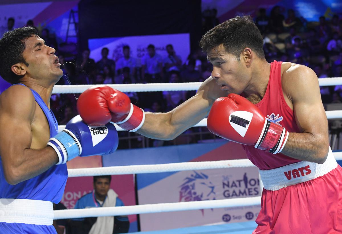 Hussamuddin Mohammed of SSCB against Satish Kumar of Uttar Pradesh in the feather weight category of men’s boxing at the 36th National Games at Gandhinagar, on Wednesday, October 5, 2022.