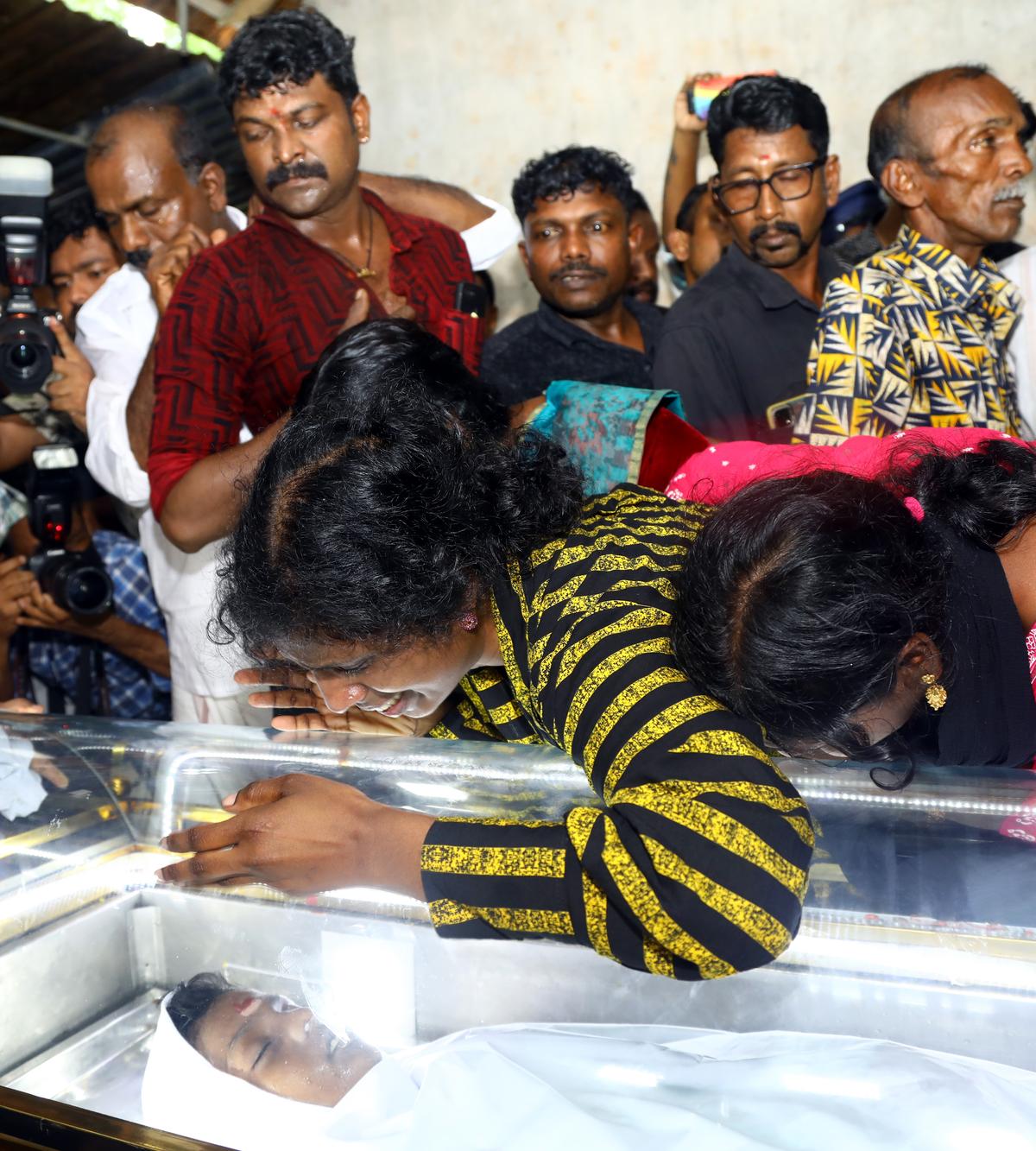  Midhun’s mother Suja breaks down over his coffin on Saturday. 