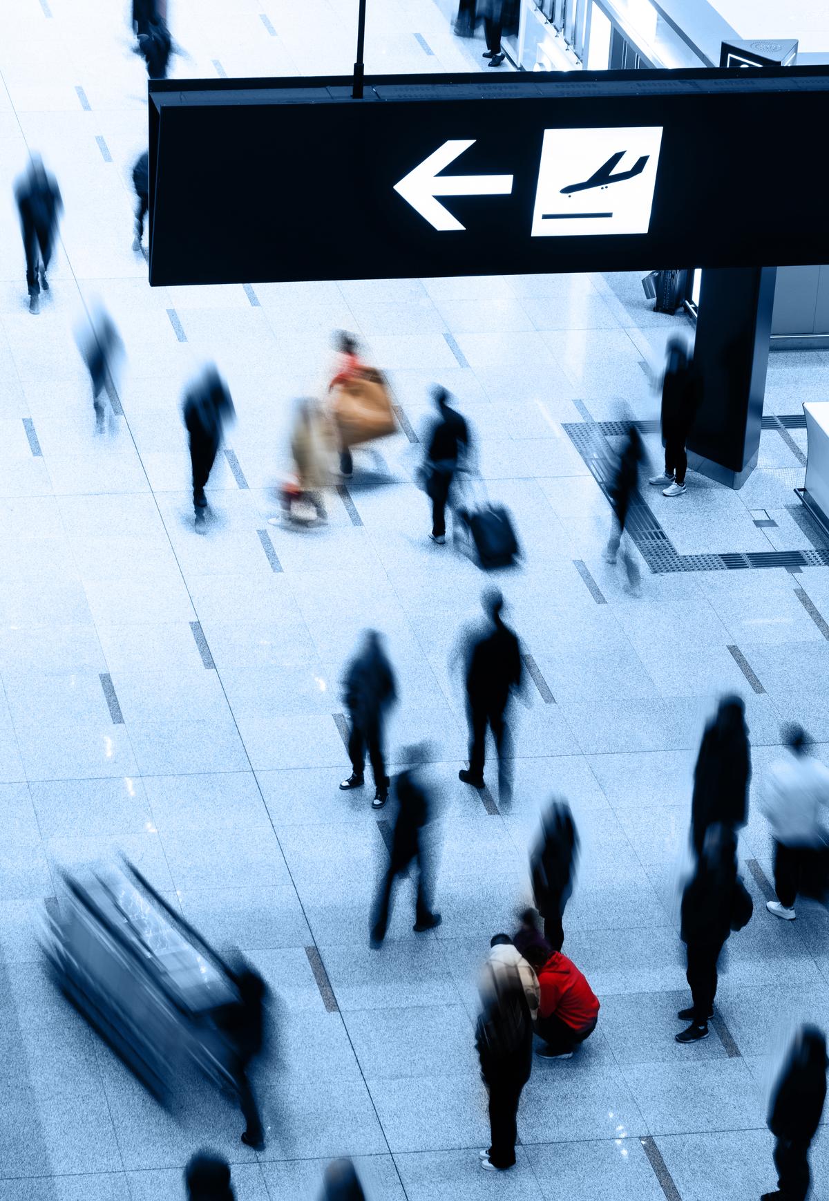 Group of people walking at the airport terminal