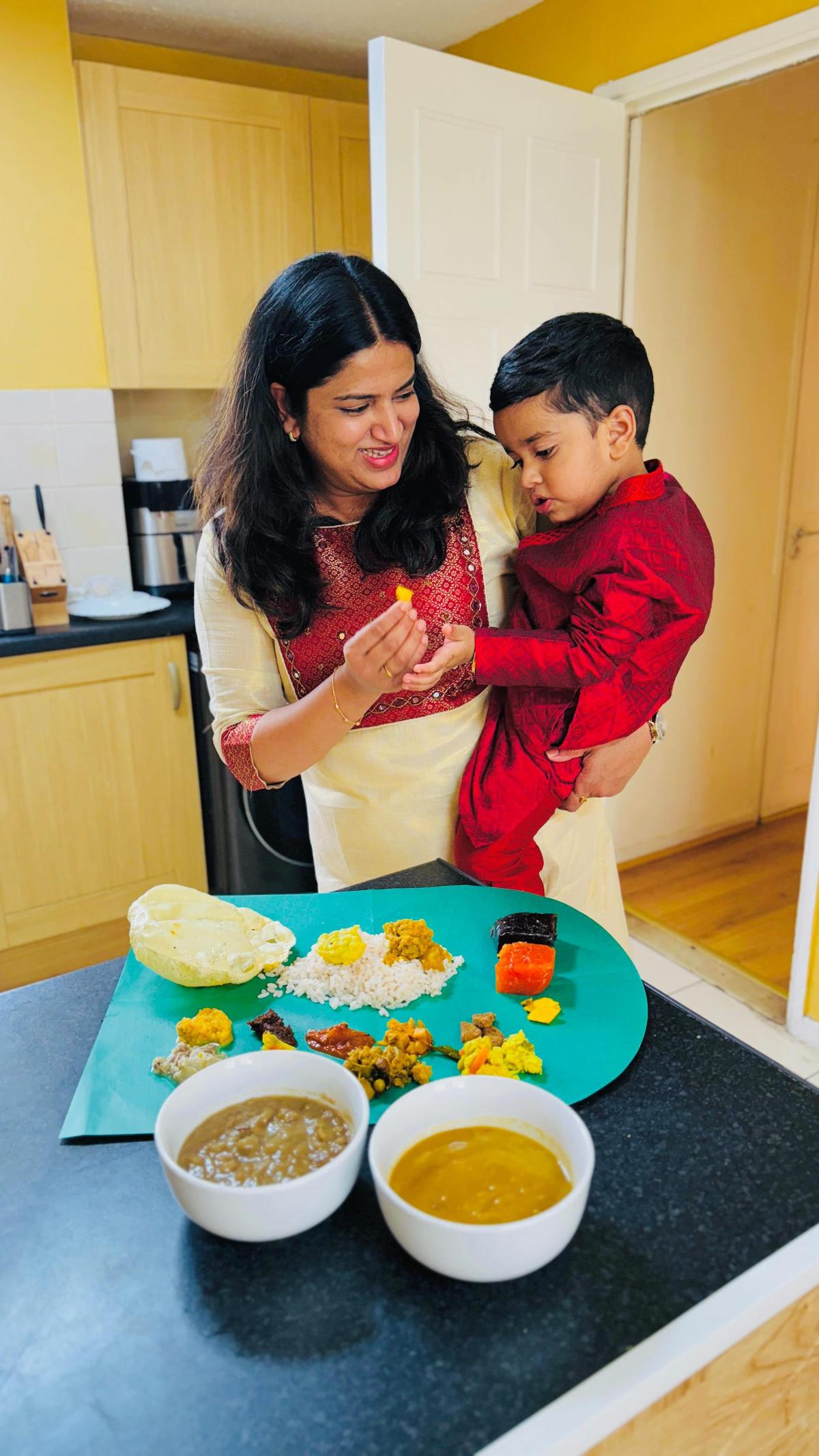 London-based Lintu Rony and son Levi Rony Eappen with the ready-to-eat Onasadya spread at their home London-based Lintu Rony and son Levi Rony Eappen with the ready-to-eat Onasadya spread at their home