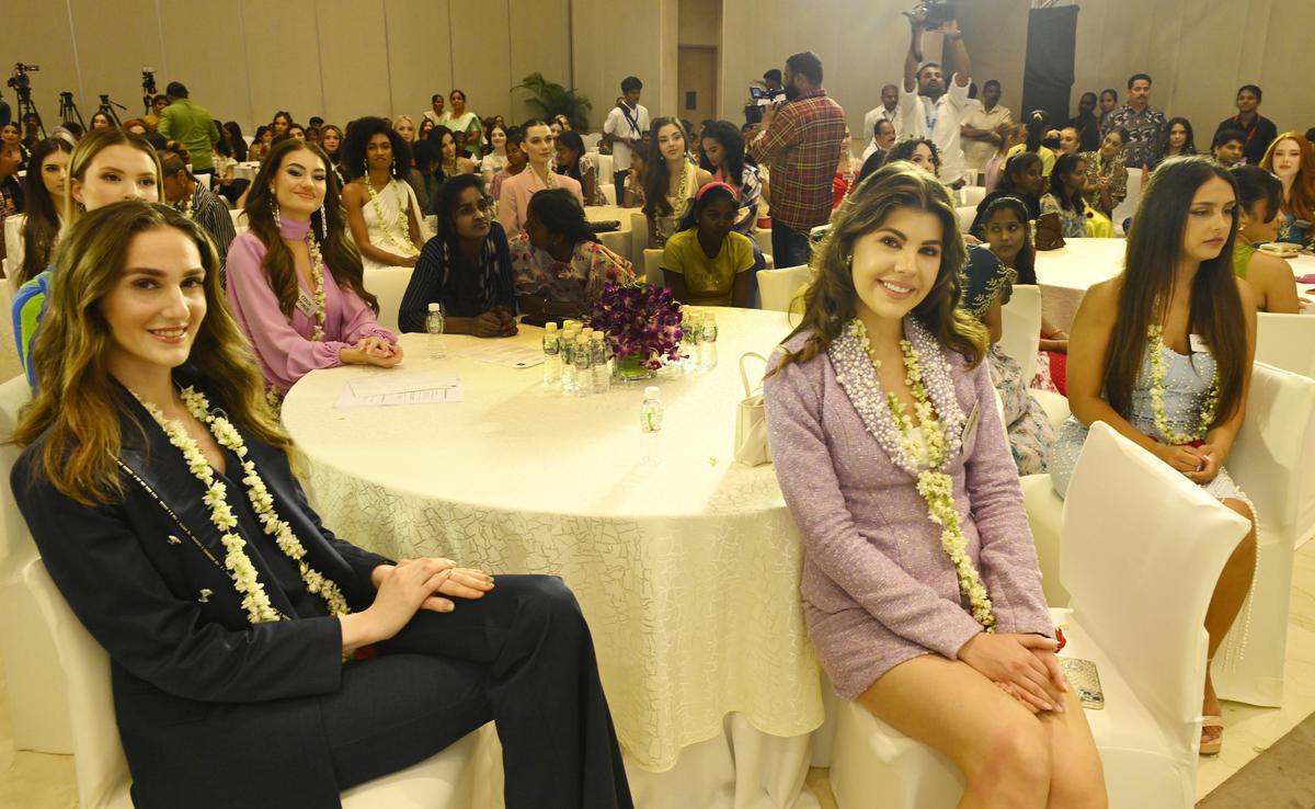 Miss World 2025 contestants hand kits to orphaned children during a charity event in Hyderabad on Wednesday.