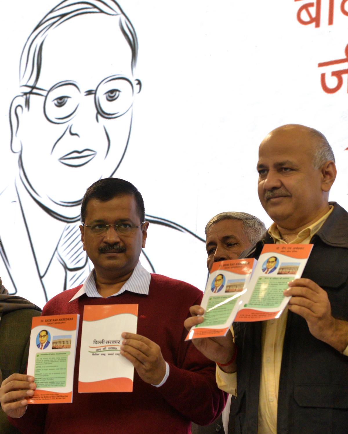 Delhi Chief Minister Arvind Kejriwal and Deputy CM Manish Sisodia release a booklet on B.R. Ambedkar.