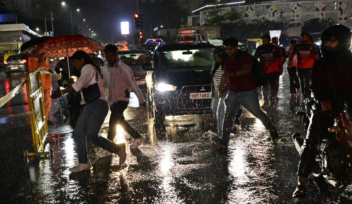 People traveled through Cubbon Road in heavy rain in Bangalore on Saturday.