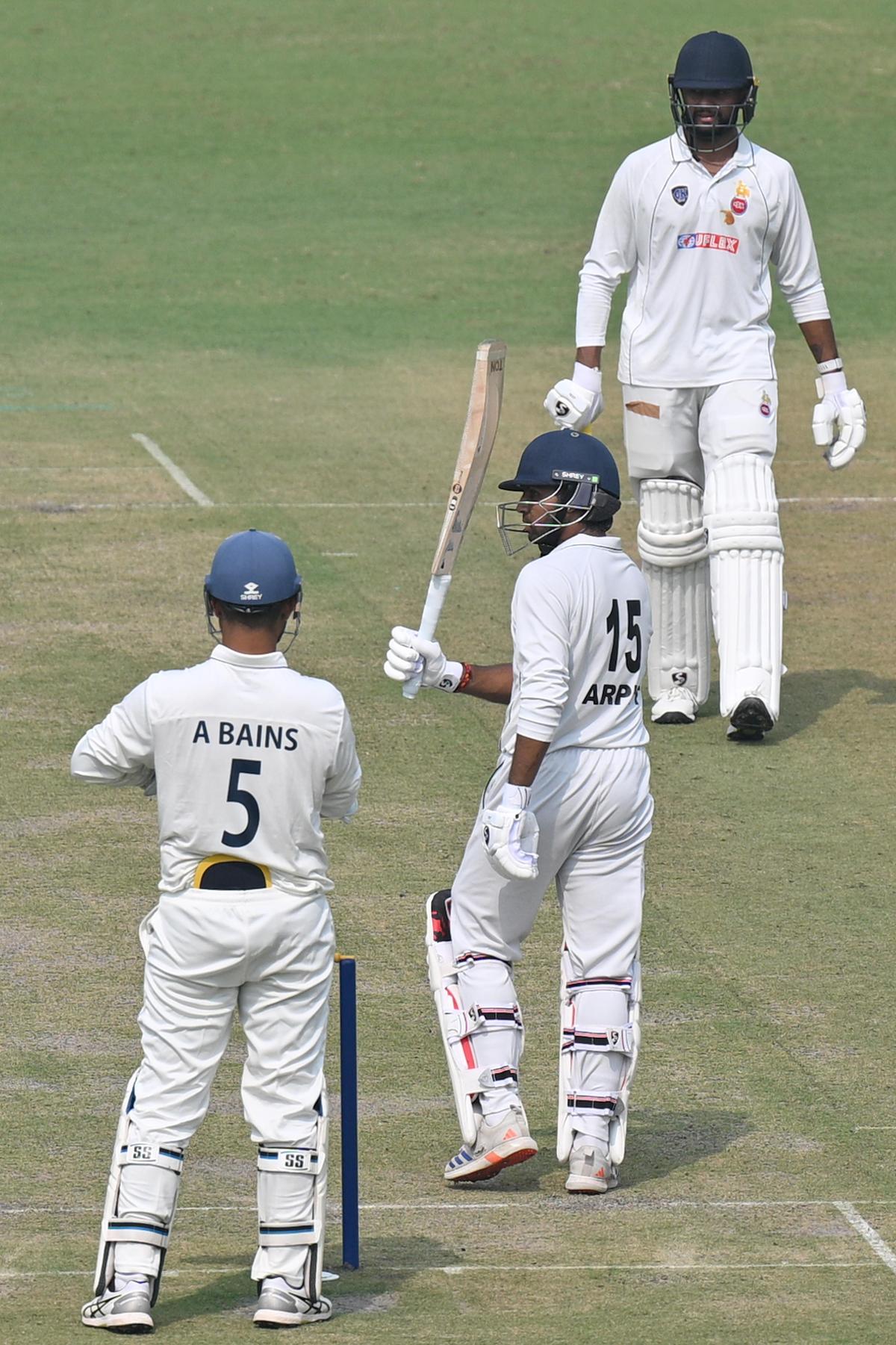Delhi player Arpit Rana celebrates after scoring a half century against Himachal Pradesh during their Ranji Trophy match at the Arun Jaitley Stadium in New Delhi on October 25, 2025. 