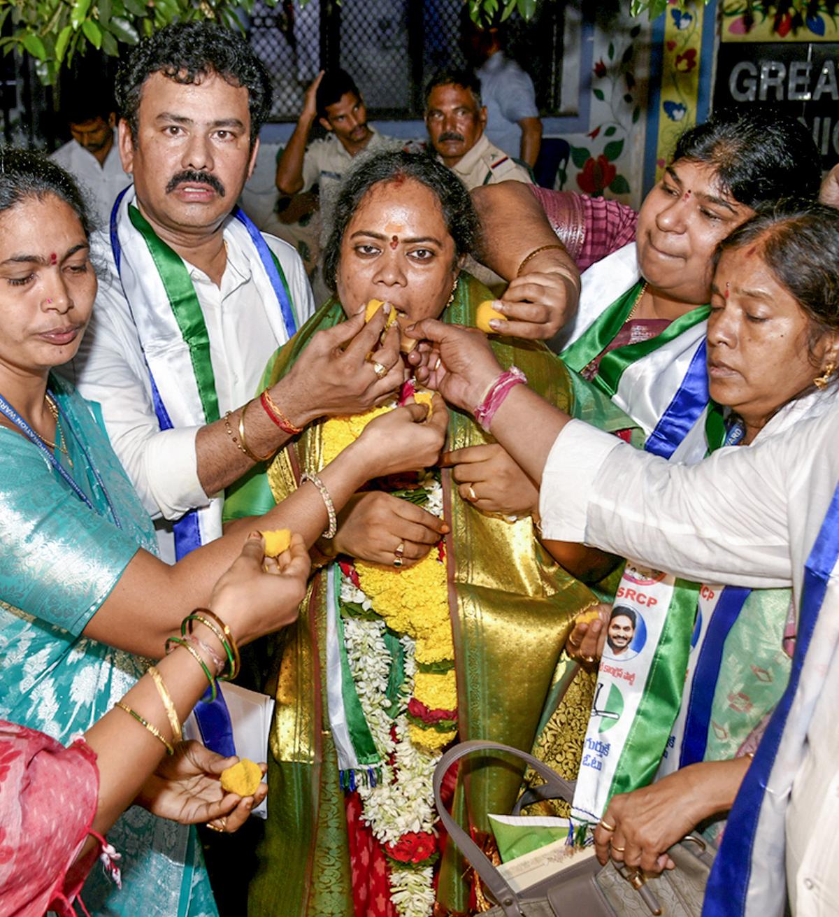 YSRCP district president K.K. Raju offering sweets to party corporator S. Padma after she won the GVMC committee elections, in Visakhapatnam on Wednesday. 