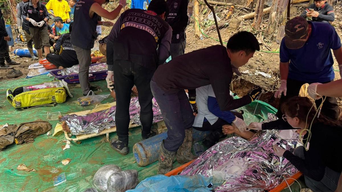 Rescuers free 4 men who had been trapped in a flooded Laos cave, search for 2 still missing