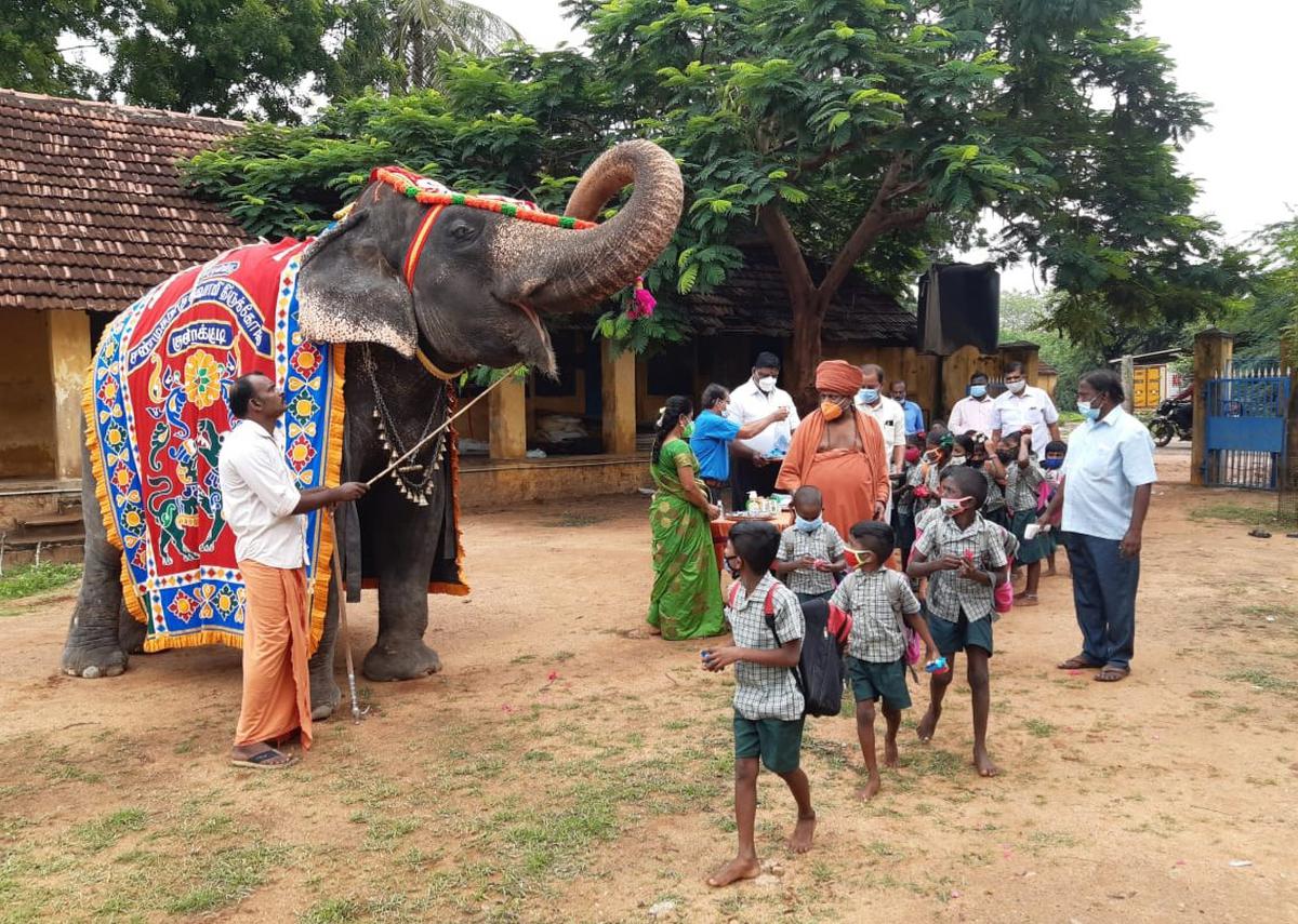 A temple elephant blessed and welcomed children at the Kundrakudi Sri Deivasigamani Arulneri Primary School near Karaikudi last year 