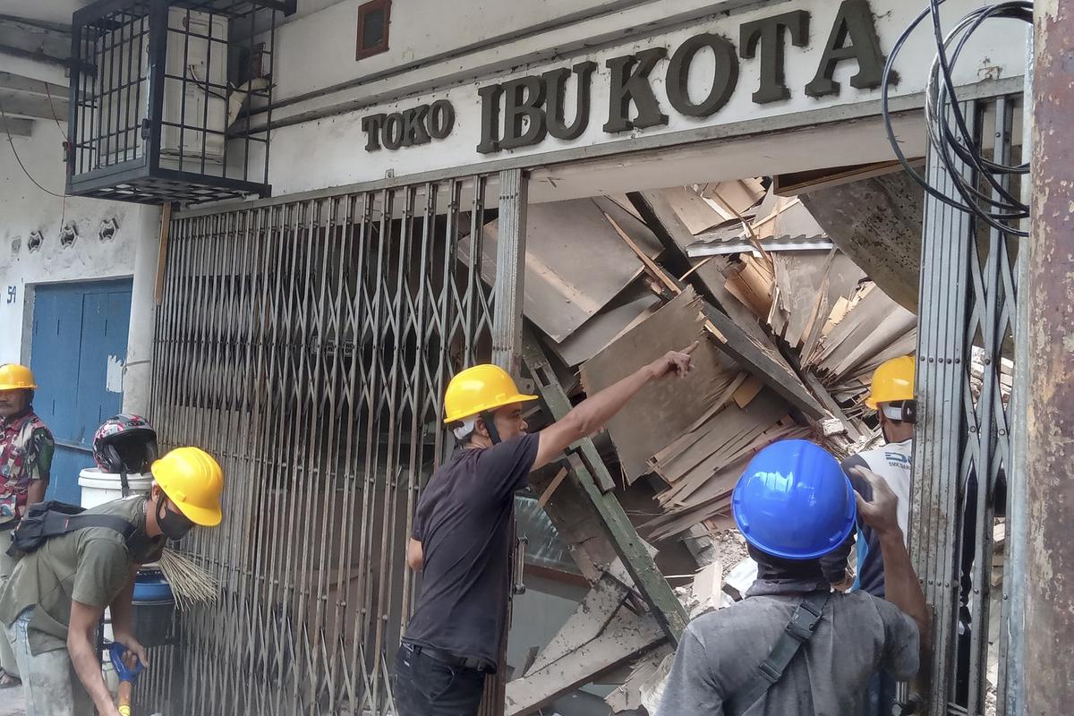 Workers inspect a store damaged during an earthquake in Cianjur, West Java, Indonesia on Nov. 21, 2022.