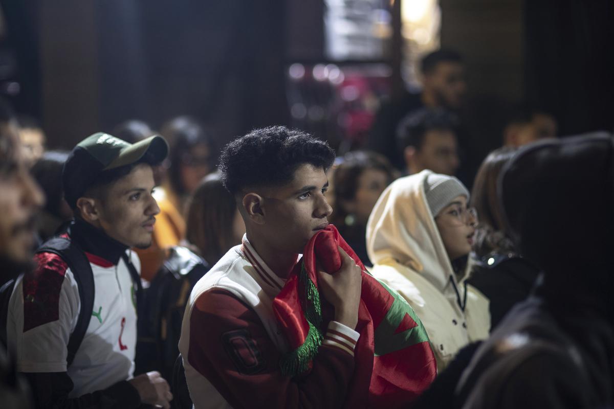 Moroccans in Rabat react while watching the Morocco national team lose to France in the semifinal of the FIFA World Cup played in Qatar