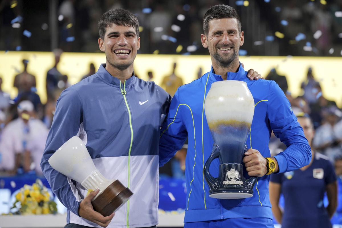 Novak Djokovic, right, of Serbia, poses with Carlos Alcaraz, left, of Spain, for photos after the men’s singles final of the Western & Southern Open tennis tournament.