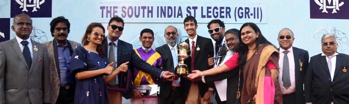 Le Reina’s trainer Imtiaz Khan (fourth from left) and jockey Suraj Narredu (fifth from left) receiving the South India St. Leger Trophy from MRC chairman M.A.M.R. Muthiah (sixth from left) in the presence of MRC committee members and other guests. Le Reina’s trainer Imtiaz Khan (fourth from left) and jockey Suraj Narredu (fifth from left) receiving the South India St. Leger Trophy from MRC chairman M.A.M.R. Muthiah (sixth from left) in the presence of MRC committee members and other guests.