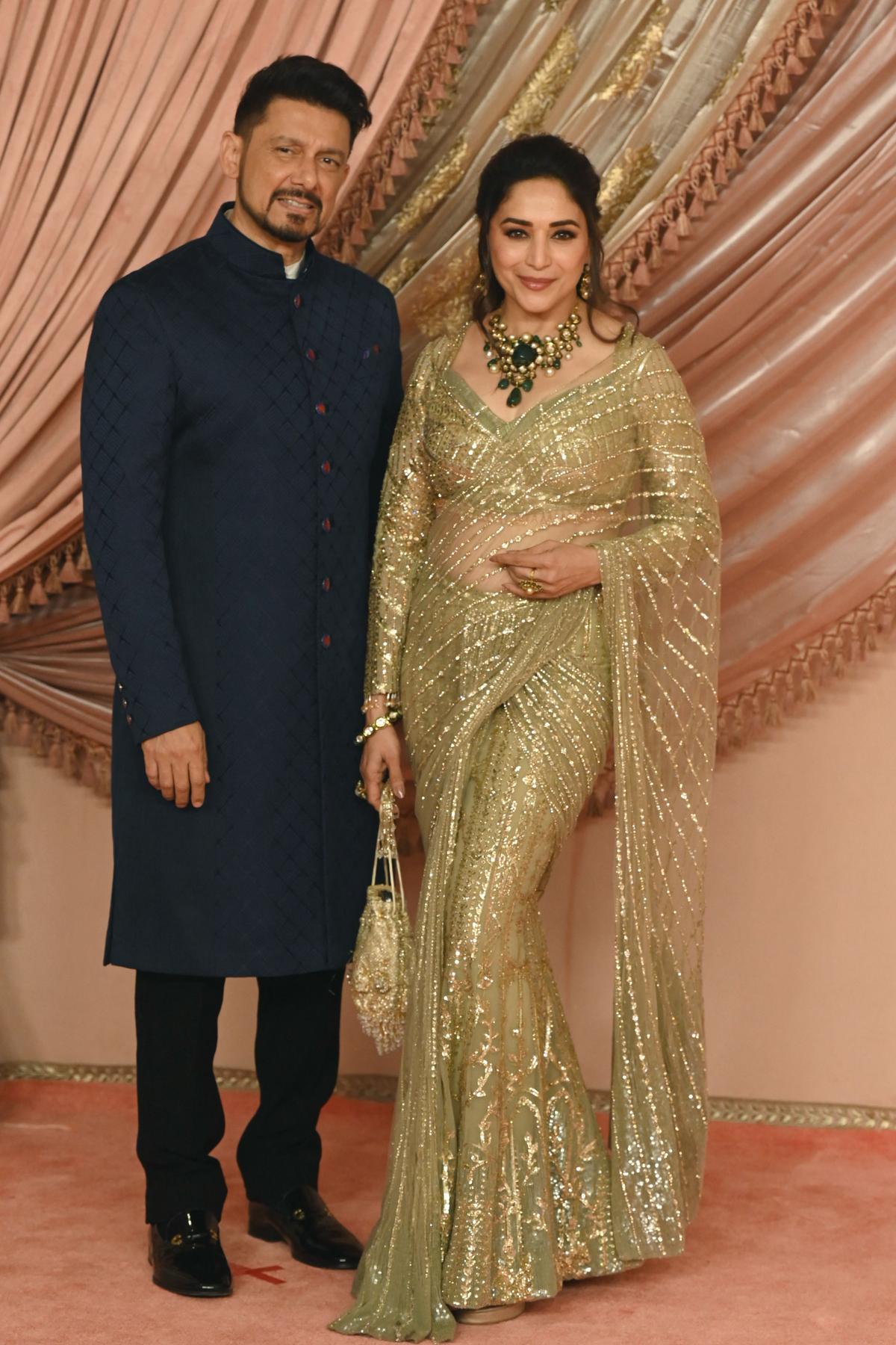 Bollywood actress Madhuri Dixit poses for a photo with her husband surgeon Shriram Madhav Nene during the Sangeet Ceremony of Anant Ambani (unseen) (son of billionaire tycoon and Chairman of Reliance Industries Mukesh Ambani) and his fiancee Radhika Merchant in Mumbai, on July 5, 2024