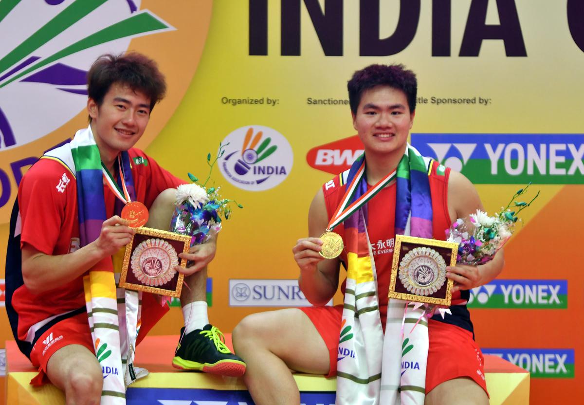 The victorious Chinese men’s pair of Liang Wei Keng and Wang Chang pose with their trophies