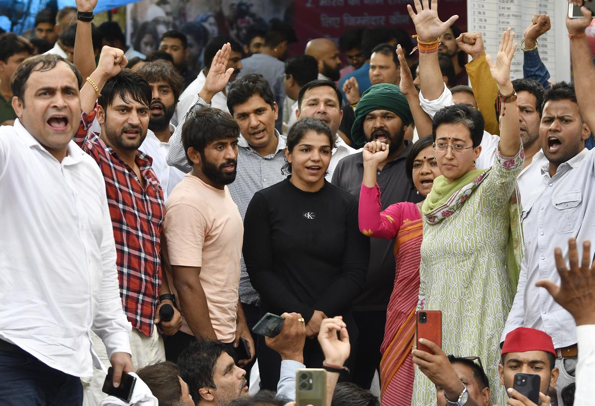 AAP leaders with wrestlers Bajrang Punia and Sakshi Malik during  their protest in New Delhi. 