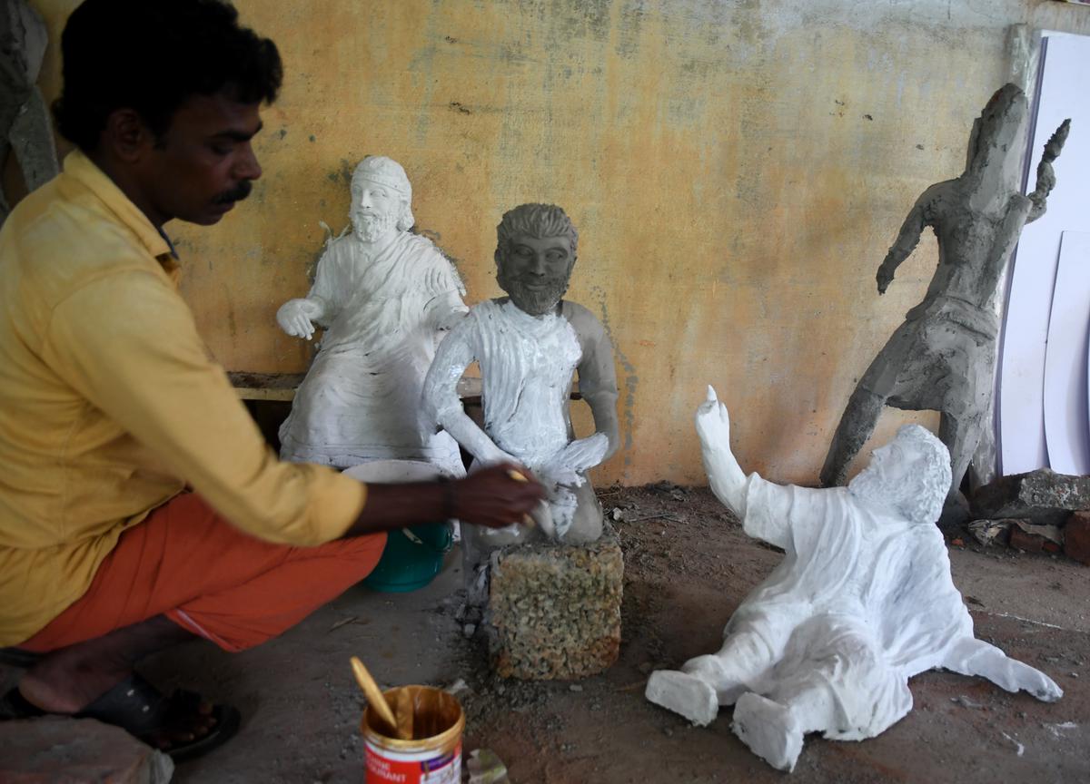 An artisan working on crib figures.