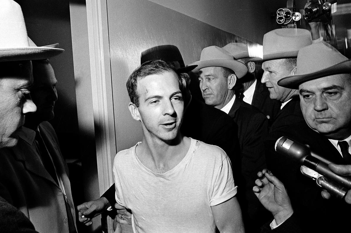  In this Nov. 23, 1963, file photo, surrounded by detectives, Lee Harvey Oswald talks to the media as he is led down a corridor of the Dallas police station for another round of questioning in connection with the assassination of U.S. President John F. Kennedy. 