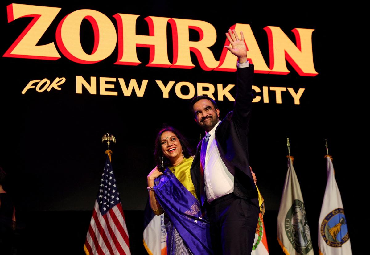 Democratic candidate for New York City mayor Zohran Mamdani waves next to his mother Mira Nair onstage after winning the 2025 New York City Mayoral race