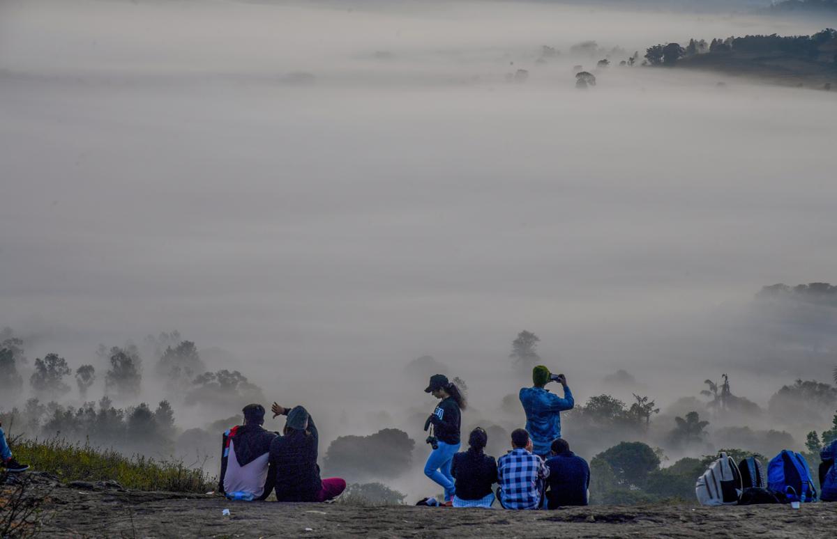 People enjoying fog engulfed araku valley from a newly discovered view piont at Madagada in Araku 130 km from Visakhapatnam
