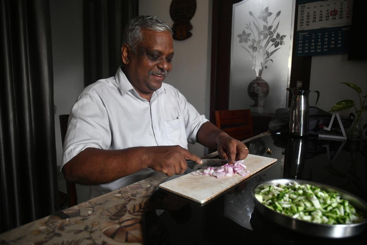 A man chops vegetables for food to be delivered to the Ernakulam Medical College. 