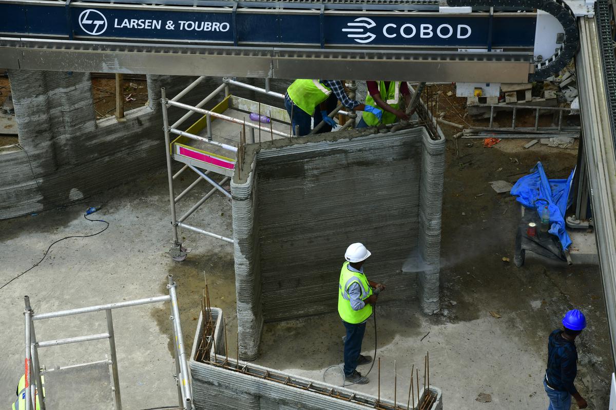 Workers at the construction of the new Ulsoor Bazaar post office building using 3D printing technology in Bengaluru on Monday. Workers at the construction of the new Ulsoor Bazaar post office building using 3D printing technology in Bengaluru on Monday.