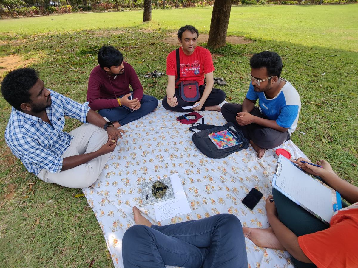 People listening to a participant during a session by Vizag Writers, a community of aspiring writers, poets and storytellers, in Visakhapatnam.