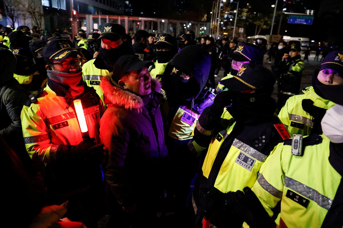 A man speaks to police officers outside the National Assembly, after South Korean President Yoon Suk Yeol declared martial law, in Seoul, South Korea on December 4, 2024. 