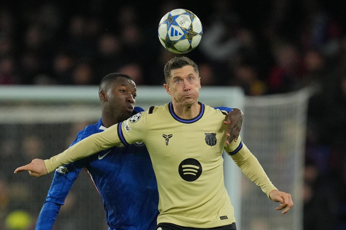 Barcelona's Robert Lewandowski, right, is challenged by Chelsea's Moises Caicedo during the Champions League match