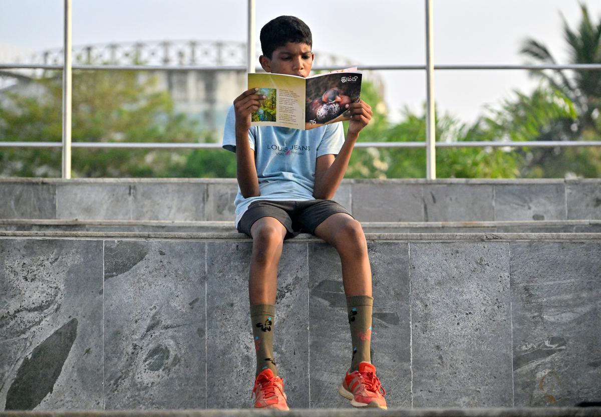 A reader sits with her book at the amphitheatre by the Chitlapakkam lake for a silent reading session by Lake Reads