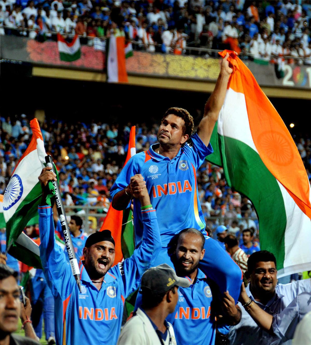 Sachin Tendulkar being carried by teammates after India's victory at the 2011 ICC World Cup in Mumbai.