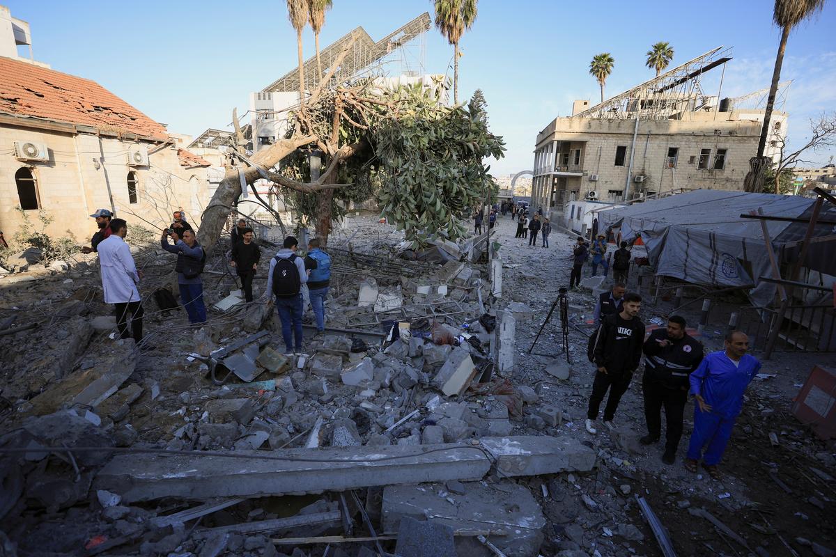 Palestinians inspect a site where medics said two Israeli missiles hit a building inside the Al-Ahli Arab Baptist Hospital in Gaza City on April 13, 2025.