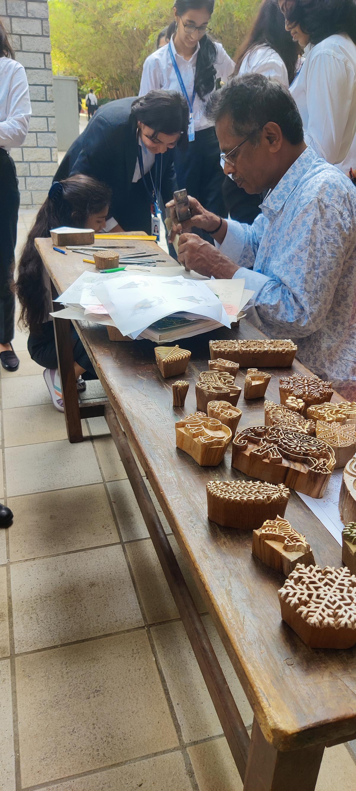 Sriram, a resource person, teaching students the art of carving blocks for block printing of textiles at the artisans’ mela, Hazaar Bazaar, held at Christ university, Bannerghatta Road, Bengaluru, from October 4 to 7.