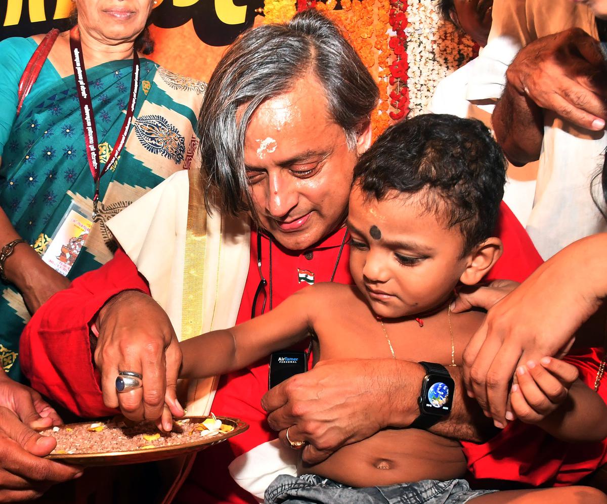 Shashi Tharoor, MP, initiates a child into the world of letters at Saraswatthy Mandapam on  Vijayadashami Day, in Thiruvananthapuram on Wednesday.