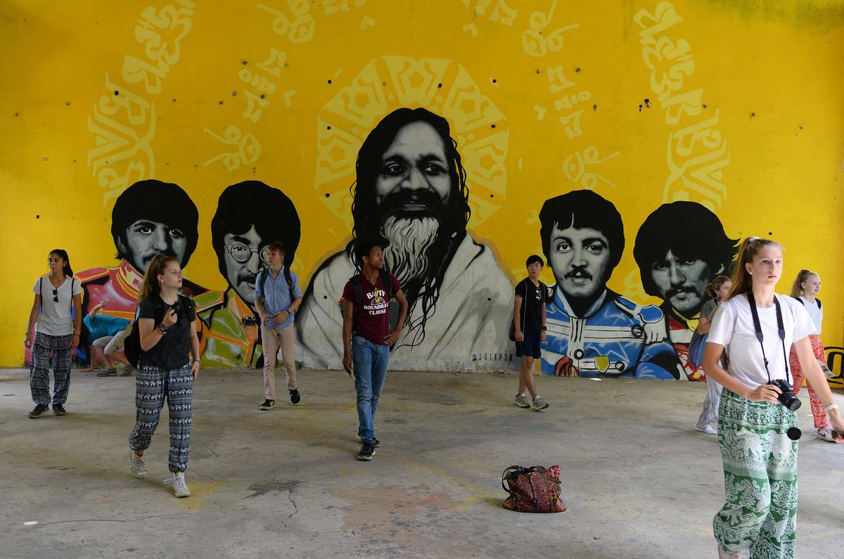 Tourists at the mural inside the Beatles Ashram in Rishikesh.