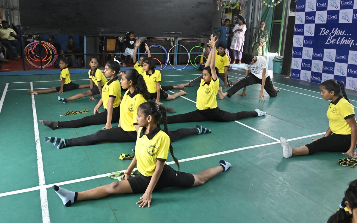 Students of ‘Chennai Hoopers’, a hula-hooping school, warming up before the class.