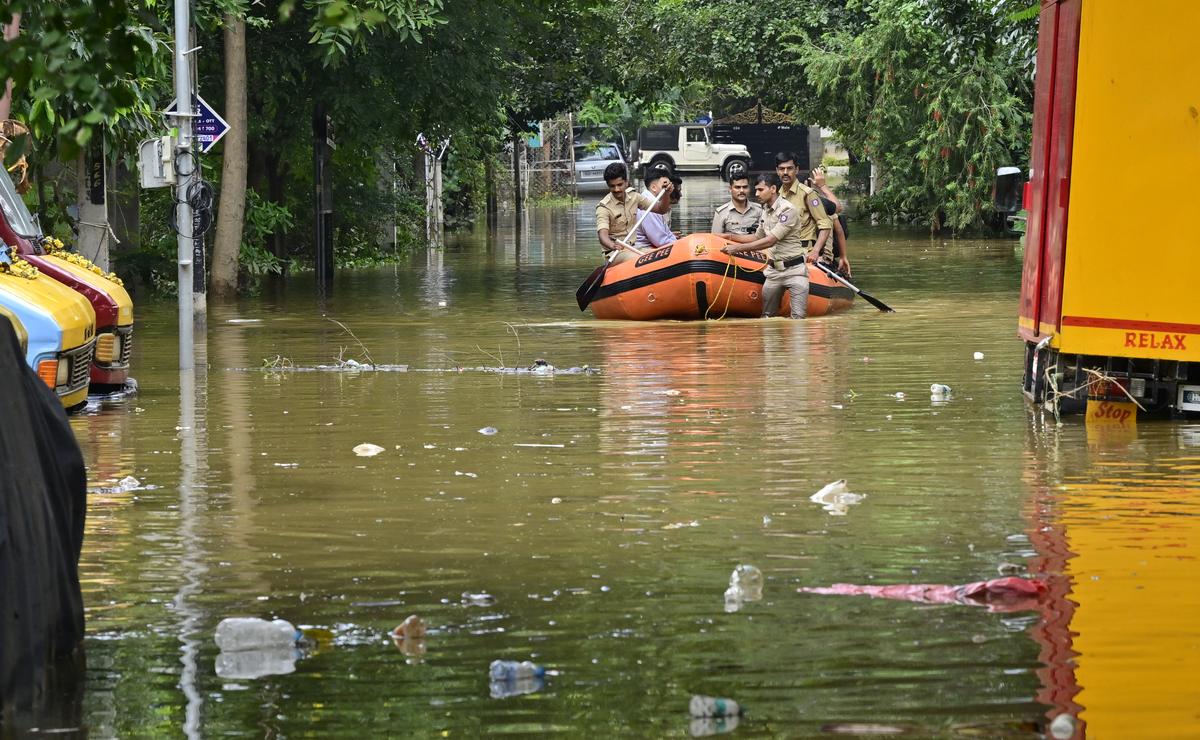 Bhadrappa layout flooded due to heavy rains on October 22. Fire personnel ferry residents in and out of their houses to buy daily supplies.  