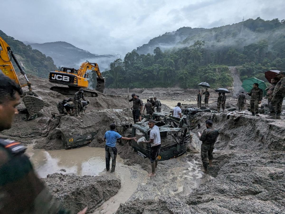 Army personnel try to recover trucks buried at the area affected by flood in Sikkim in this undated image released by the Indian Army on October 5, 2023. Photo: India Army/Handout via Reuters