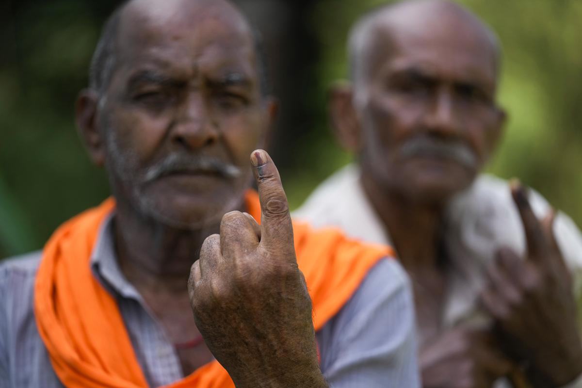 West Pakistan refugees, Rattan lal Chodhary, left and Satpal Chodhary, show the ink mark on their fingers after casting their vote at a polling booth in RS Pura, Jammu and Kashmir, on October 1, 2024. 