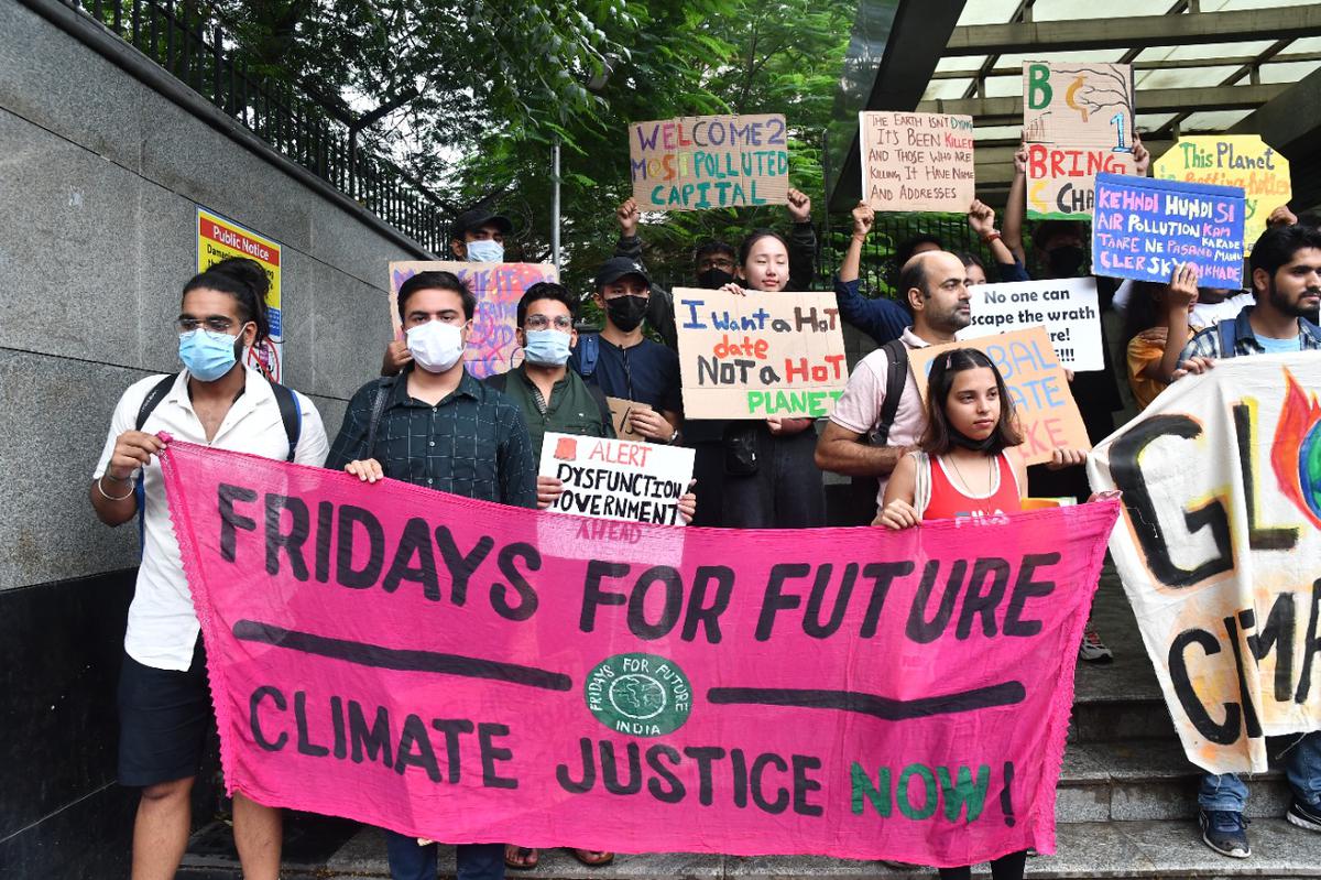 Protestors hold placards during a protest march from ITO to Delhi Secretariat against global climate strike,“ Friday for future climate justice now”, at ITO in New Delhi, on September 23, 2022. 