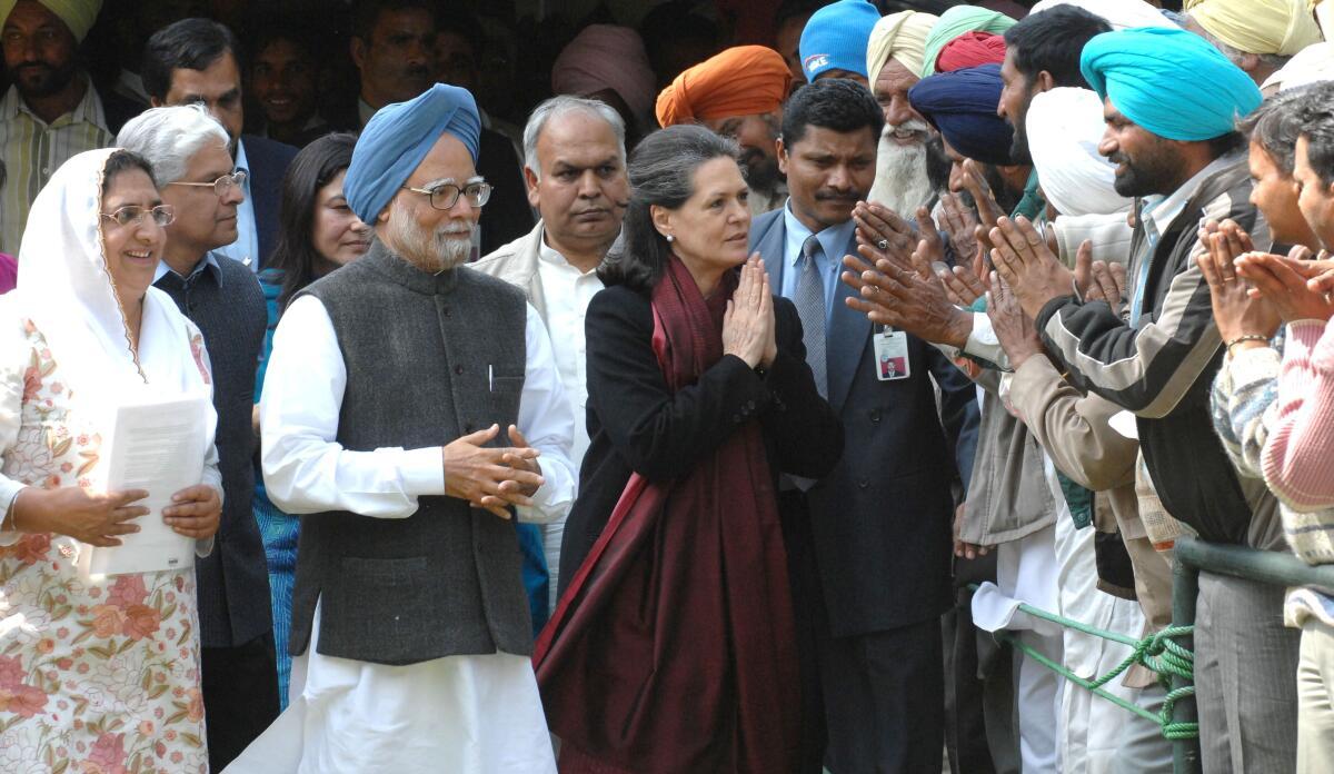 File photo: Prime Minister, Manmohan Singh along with UPA Chairperson and Congress President, Sonia Gandhi being greeted by the farmers from Punjab who met them to thank the UPA Government for waiving off their loans, watched by Punjab Congress Chief, Rajinder Kaur Bhattal (ext L) in New Delhi on February 25, 2008