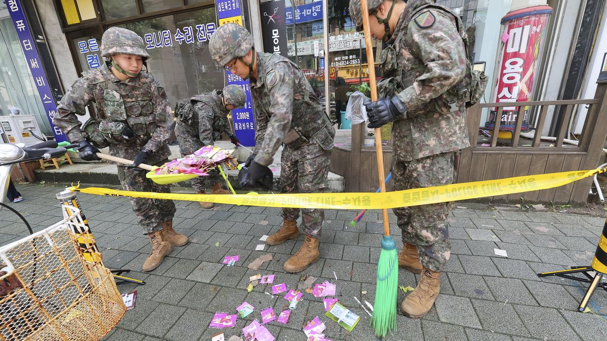 Trash dropped by a North Korean balloon falls on South Korea's Presidential compound