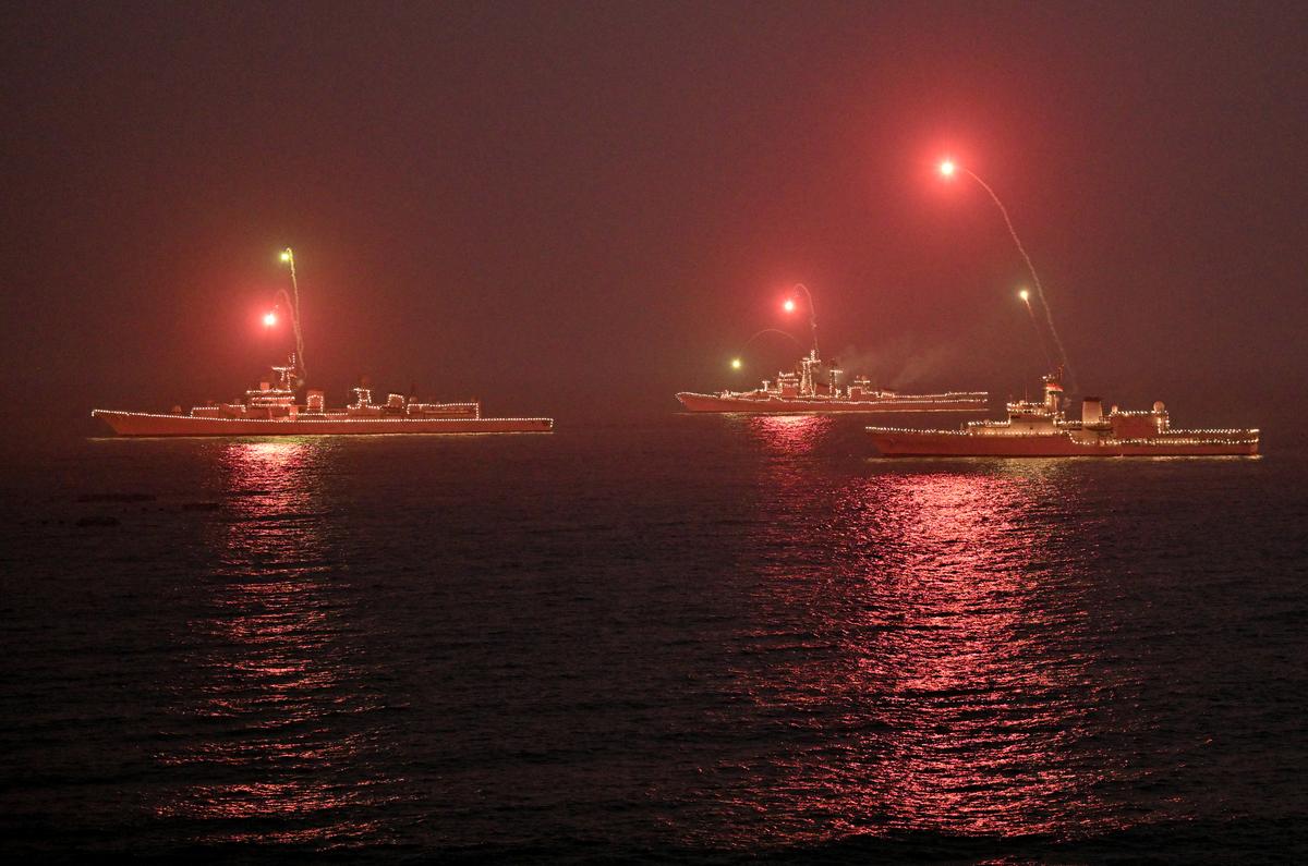 Naval ships illuminated firing flares at the Beach Road in Visakhapatnam during the rehearsals for the Operational Demonstration of Indian Navy.