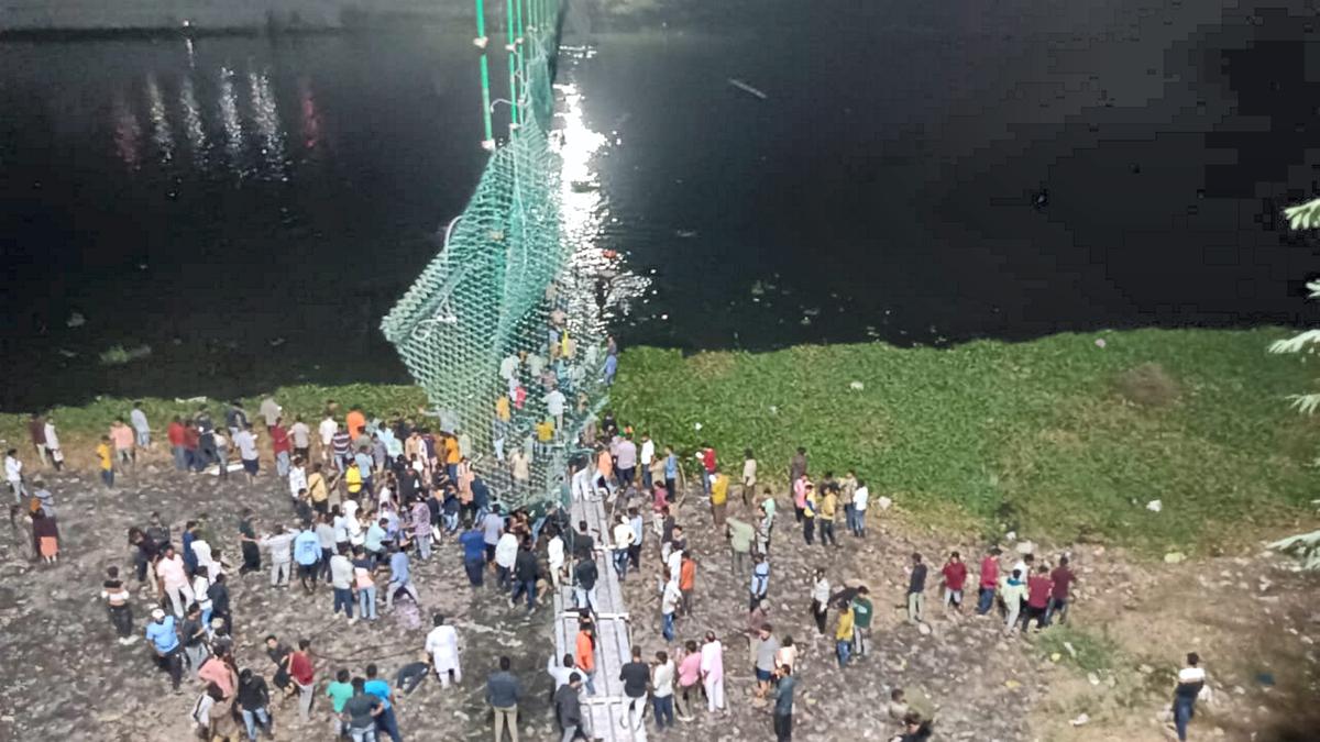 Rescue operation under way after an old suspension bridge over the Machchhu river collapsed, in Morbi district, on Oct. 30, 2022